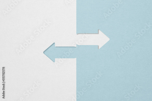 opposite directions arrow paper cut grey and blue with copy space photo