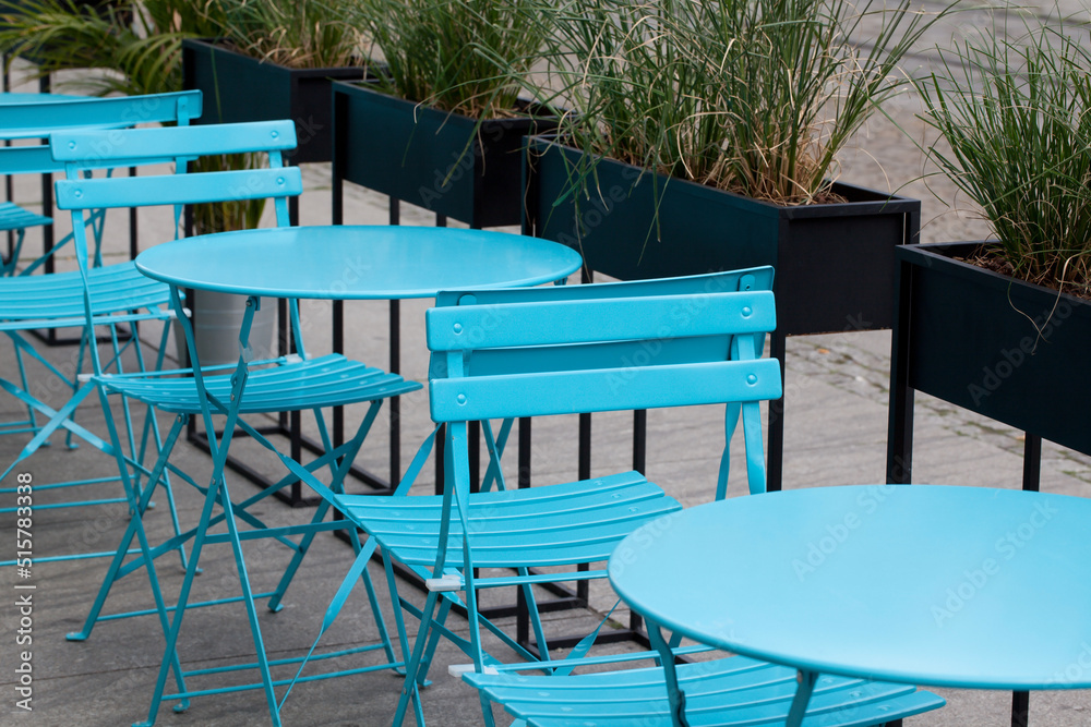 Blue chairs and tables in the restaurant, exterior.