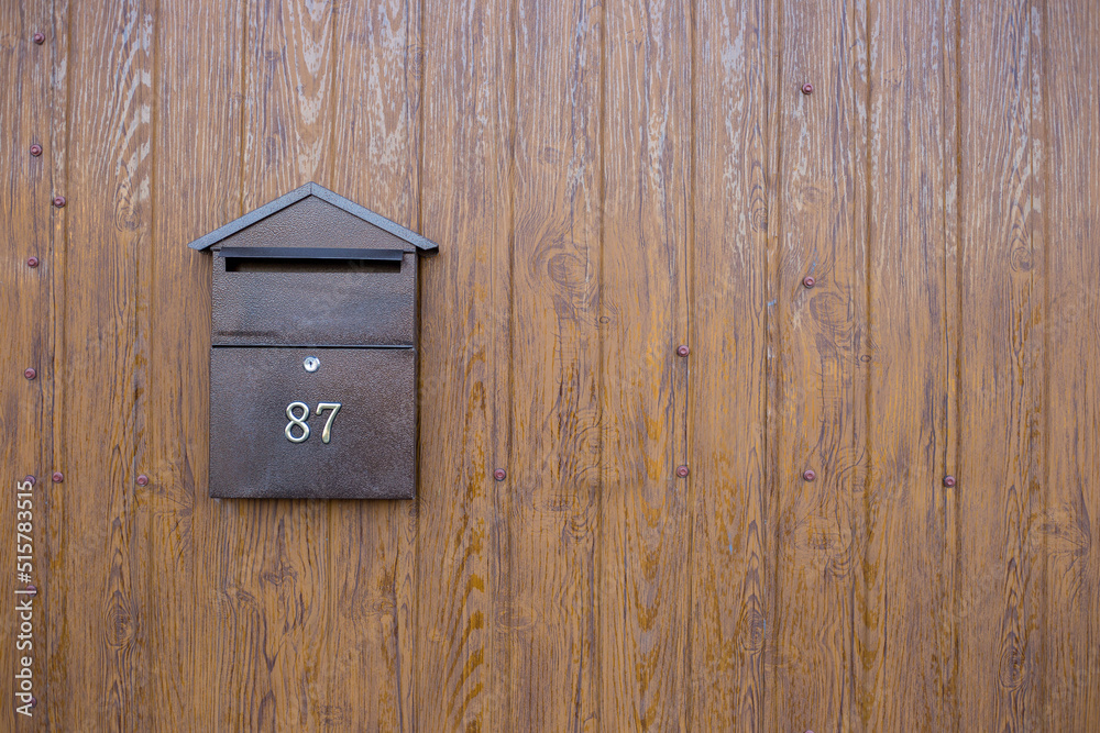 Metal mailbox on the wooden background. Box for letters and correspondence Metal mailbox on the wooden background. Box for letters and correspondence