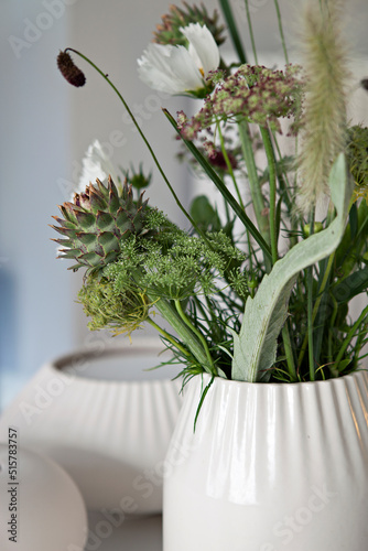 Green flower bouquet in white porcelain vase photo