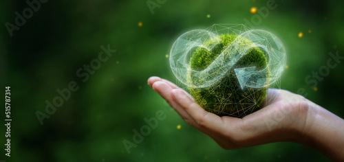 businessman holding circular economy icon Circular economy concept for future business growth and environmental sustainability and reduce pollution for future business and environmental growth. photo