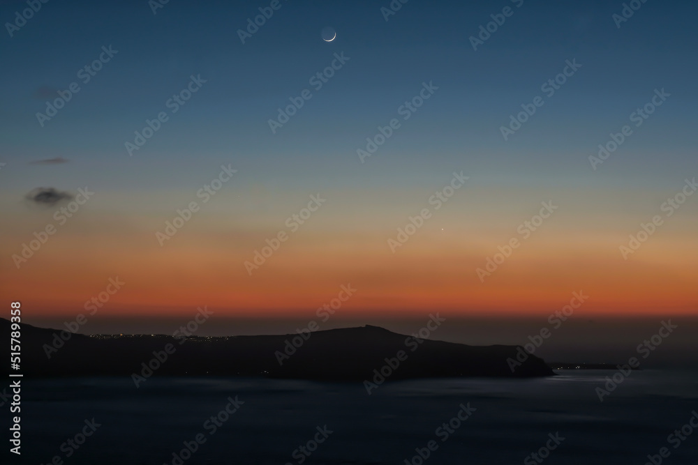 Panoramic view of the caldera, the volcano of Santorini and a beautiful colourful sky