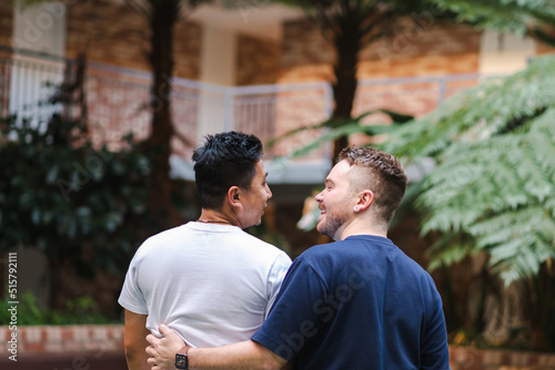 mixed race gay couple hugging photo