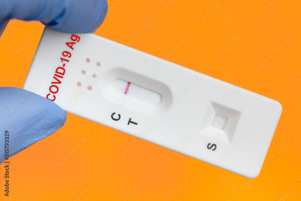 Covid19 antigen test kit on orange background. Negative diagnosis of