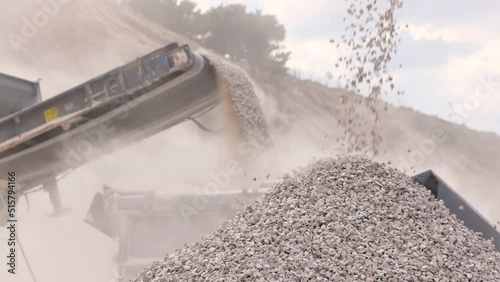 Stone crushing machine at open pit mining and processing plant for gravel stone. Piles of crushed stone and conveyor belts. Concepts of industry and building materials, sand and gravel, slow motion