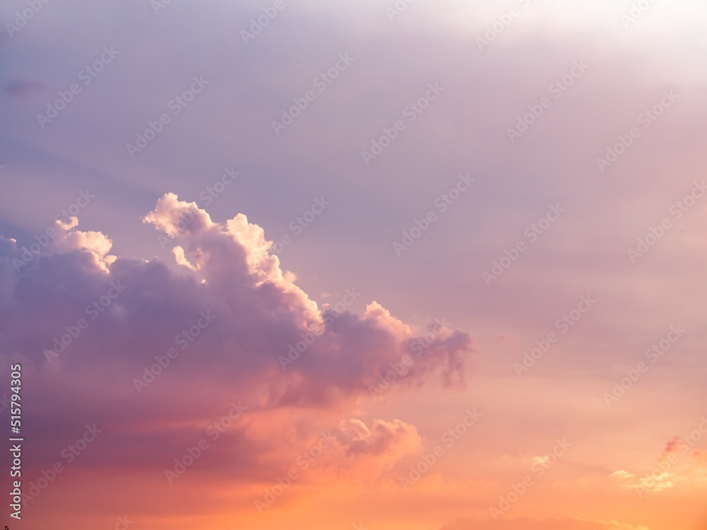 Fototapeta premium Cloudy sky during thunderstorm. Cumulus clouds shines orange and pink at the horizon during the weather changes. Weather, clouds, temperature and meteorology.