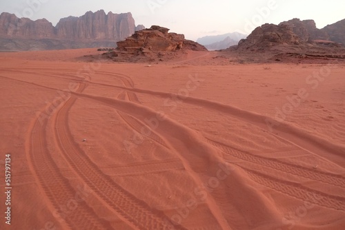 Amazing scenery of Wadi Rum Desert looks like Mars. Traces of off-road car tires on red sand.