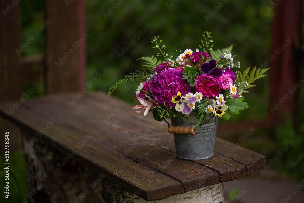 summer garden flowers bouquet in vintage basket