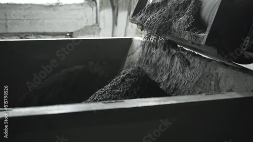 Close up of conveyor belt with crushed stone, shooting in slow motion. Equipment for separation and transportation raw building materials