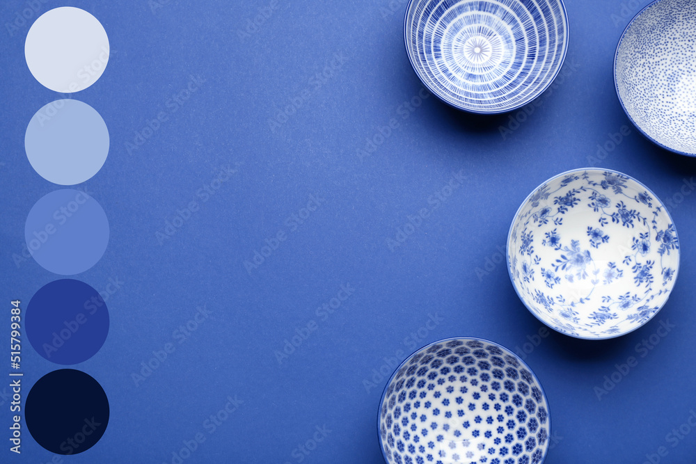Beautiful Chinese bowls on blue background. Different color patterns