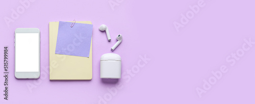 Notebook with note paper, mobile phone and earphones on color background with space for text