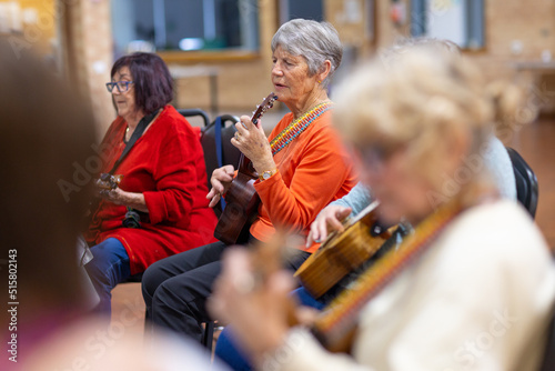 group of senior women playing ukulele photo