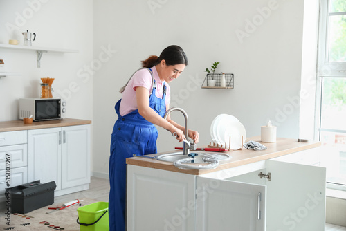Asian female plumber fixing...
