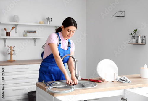 Asian female plumber fixing...