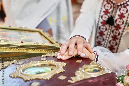 A young couple makes a marriage vow on the Gospel during a church wedding.