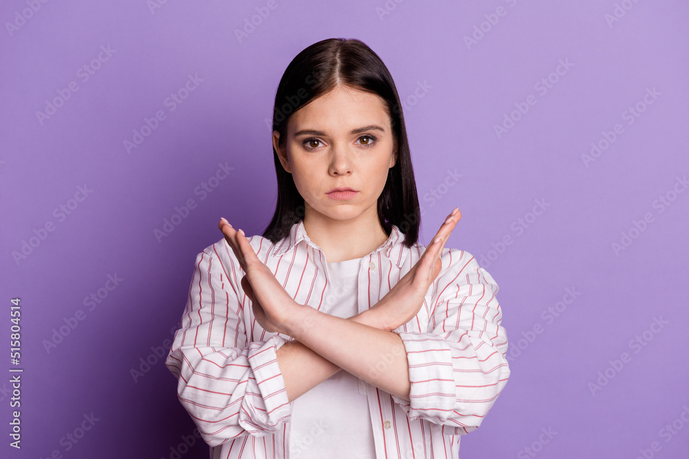 Photo of young girl crossed hands show forbidden rule symbol decline isolated over violet color background Photo of young girl crossed hands show forbidden rule symbol decline isolated over violet color background