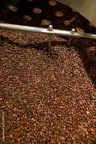 Fresh organic coffee beans mixing in roast machine