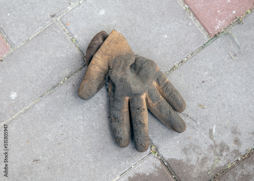 The worker's glove lies on the paving slab. © schankz