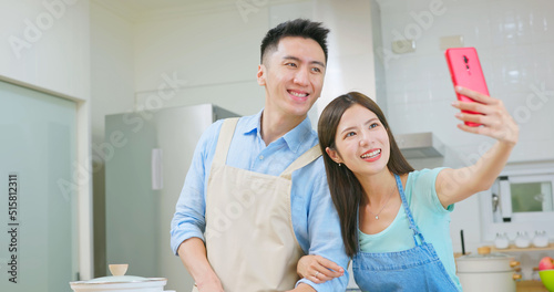 young couple are cooking together photo