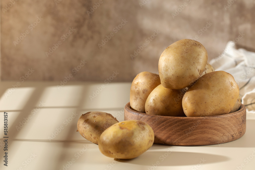 Raw potatoes in a bowl. The concept of harvesting, organic food. Raw potatoes in a bowl. The concept of harvesting, organic food.