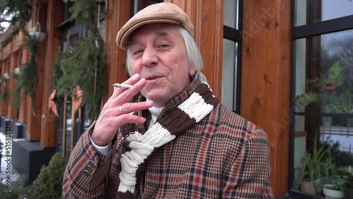 Slow Motion Adult man in winter clothes standing against building