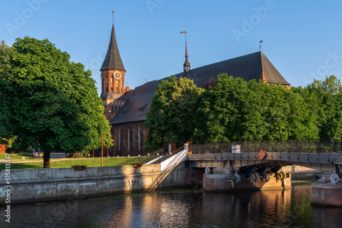 View of the Koningberg Cathedral on Immanuel Kant Island against the background of the Honey Bridge over the Pregolya River on a sunny summer day, Kaliningrad, Russia