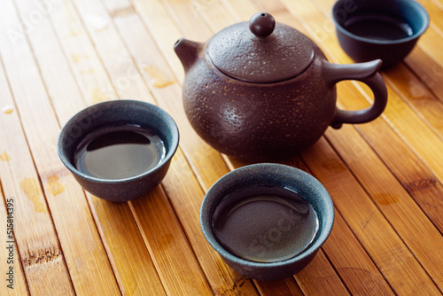 tea set on a table with a bamboo mat.
