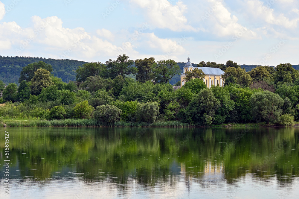 chapel among the trees on the lake
