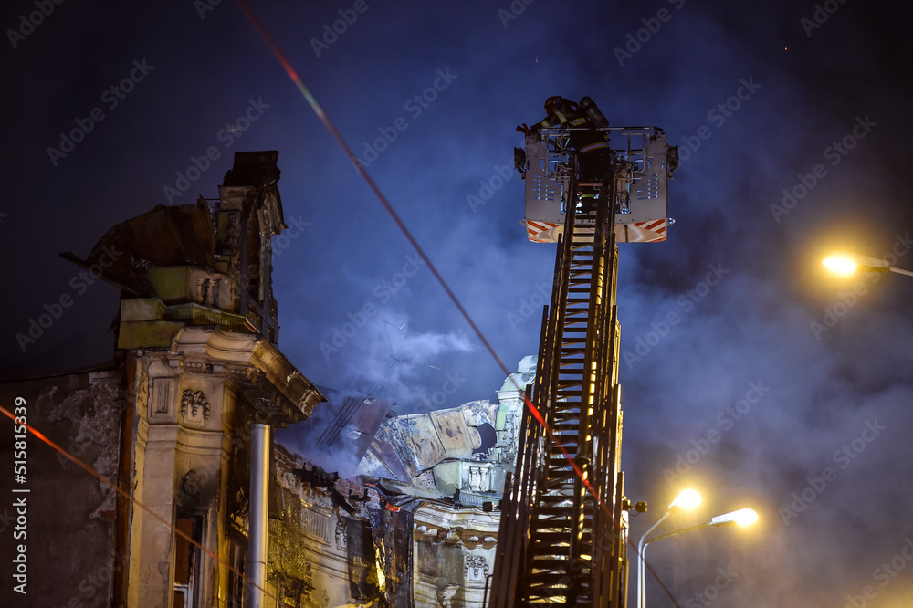 Firefighters trying to extinguish fire on historical building caught on