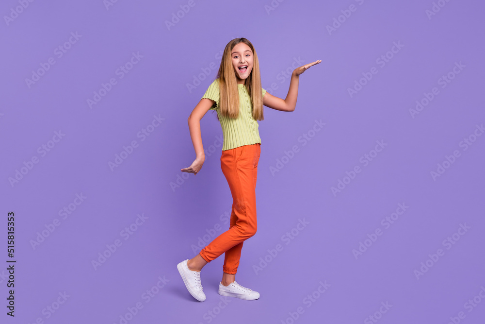 Full size profile portrait of cheerful nice girl enjoy dancing arms make moves isolated on purple color background Full size profile portrait of cheerful nice girl enjoy dancing arms make moves isolated on purple color background