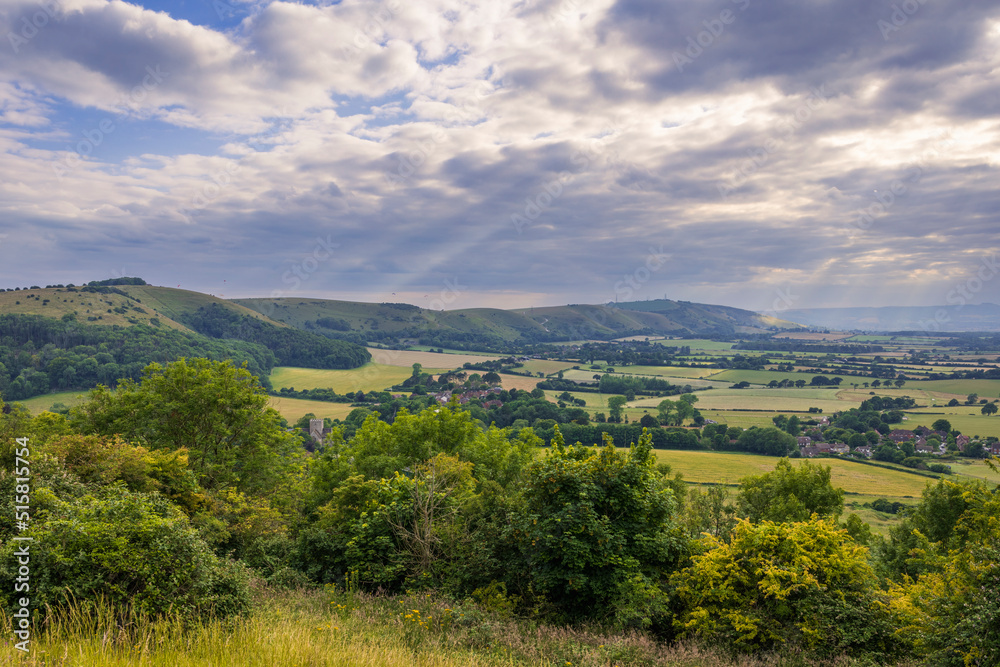 Fototapeta premium Beautiful views west over the village of Poynings from Devils Dyke to Chanctonbury ring on the south downs in west Sussex south east England UK