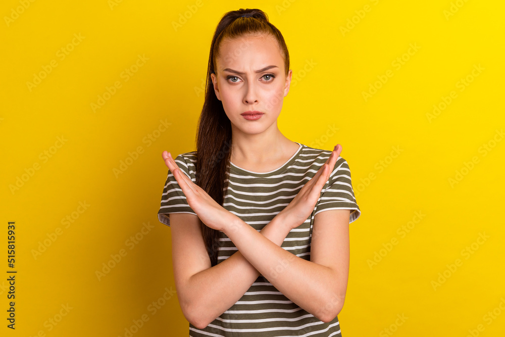 Confident young woman is showing no sign with crossed hands studio shot on vibrant color background. Confident young woman is showing no sign with crossed hands studio shot on vibrant color background.