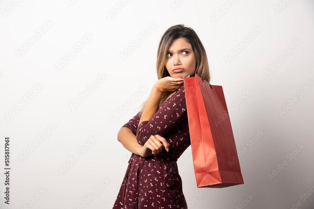 Young woman holding shopping bag on white background Young woman holding shopping bag on white background