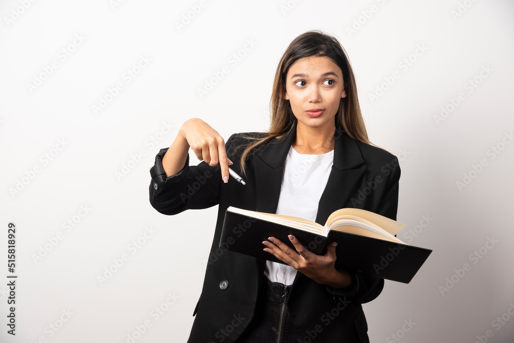 Young businesswoman holding an opened clipboard with pencil Young businesswoman holding an opened clipboard with pencil