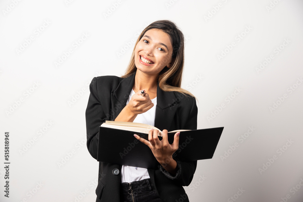 Young businesswoman holding clipboard with pencil Young businesswoman holding clipboard with pencil