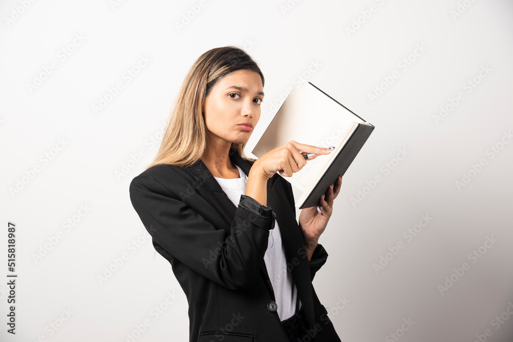 Young businesswoman pointing at clipboard Young businesswoman pointing at clipboard