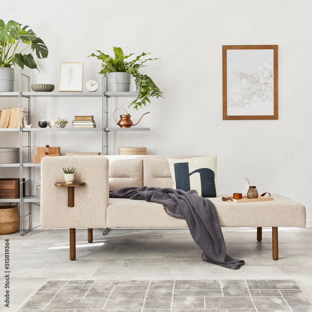 Obraz premium Cozy interior with stylish sofa, design coffee table, bookcase, plants, carpet, decoration, mock up poster map and elegant personal accessories. Neutral living room in classic house. Template.