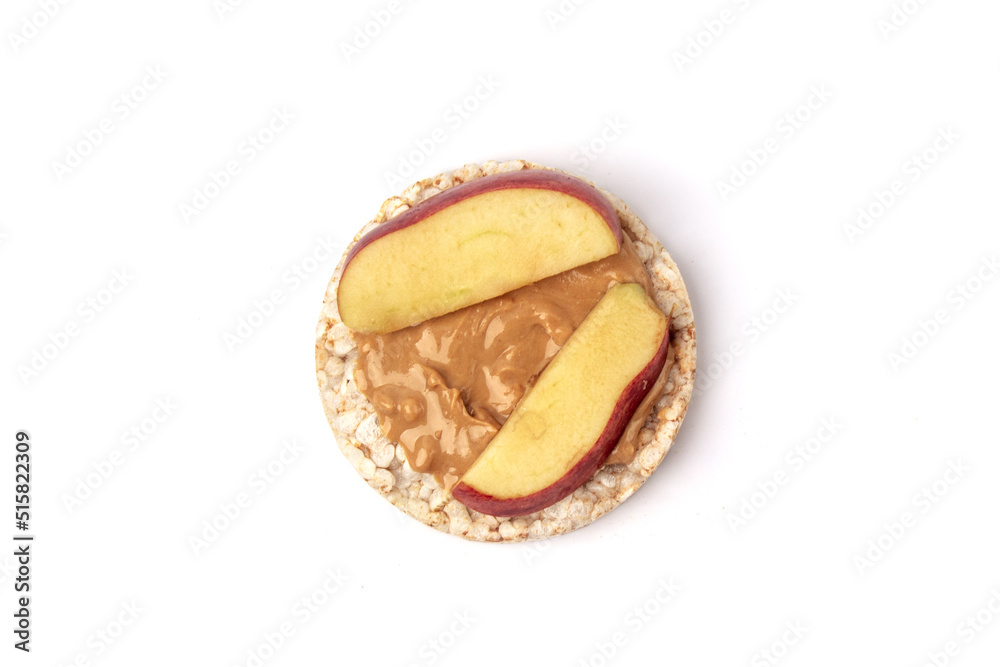 Isolated rice cake with peanut butter and slice of apple Isolated rice cake with peanut butter and slice of apple