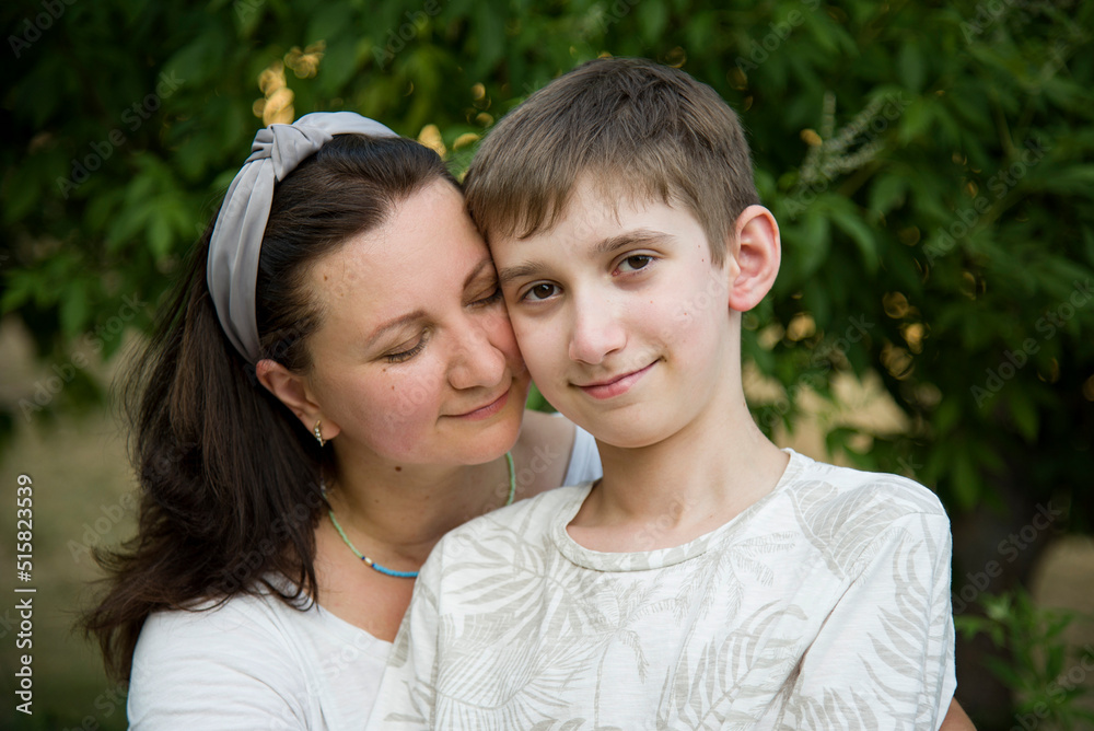 portraite of smiling happy mother with his son in summer park portraite of smiling happy mother with his son in summer park