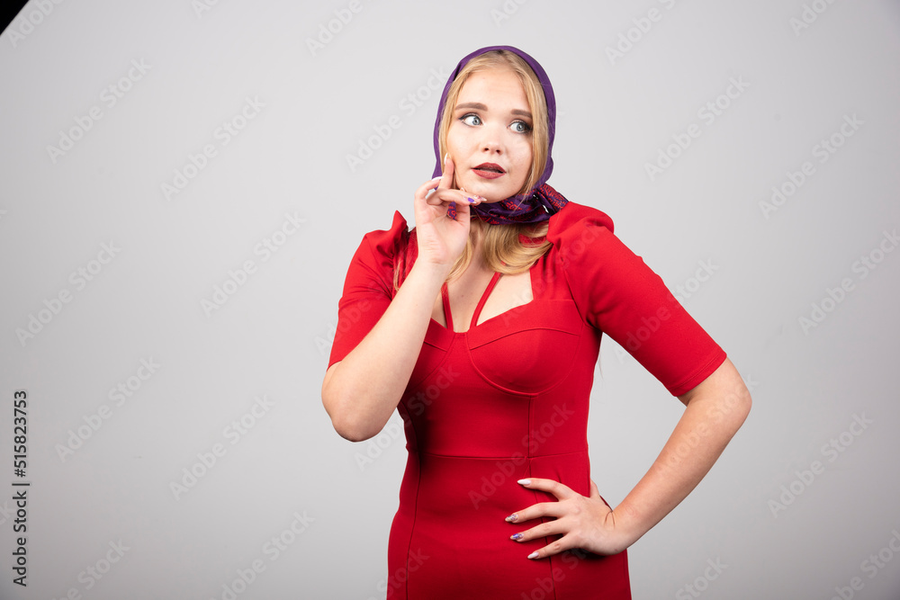 Young woman in red dress looking at somewhere