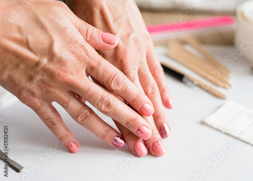 Nail manicure. Woman beautiful nail care process. Manicure in the salon or at home. Nail care. Close-up