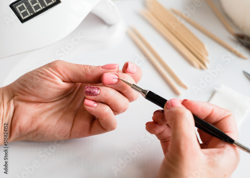 Manicure for yourself. Strengthening natural nails with artificial gel material. Nail care. Close-up