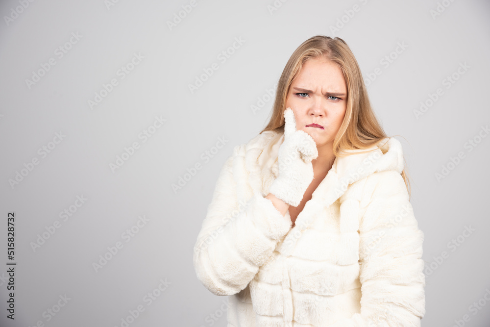 Beautiful woman in winter outfit looking angry Beautiful woman in winter outfit looking angry