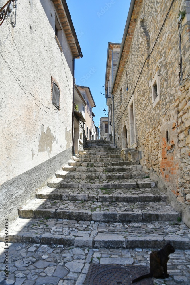 A narrow street between the old houses of Pietrelcina a village in the province of Benevento, Italy.	