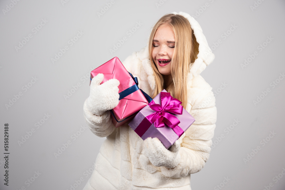 Young blonde woman looking at Christmas gifts Young blonde woman looking at Christmas gifts
