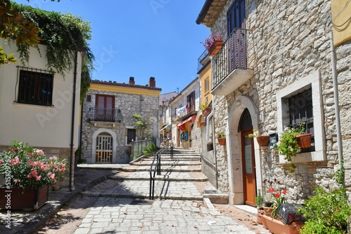 A narrow street between the old houses of Pietrelcina, a village in the province of Benevento, Italy.	 photo