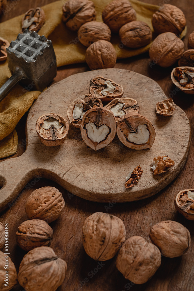 Wooden board with open dried walnuts. Walnut peeling process, Healthy diet concept. Wooden board with open dried walnuts. Walnut peeling process, Healthy diet concept.
