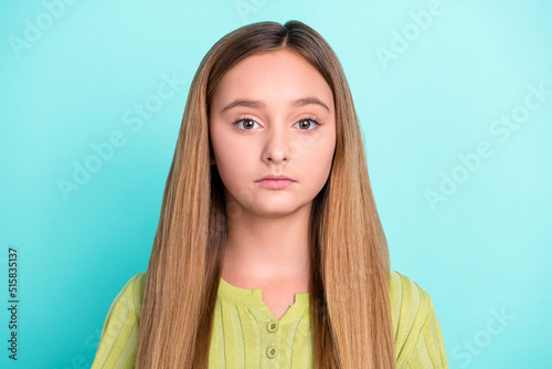 Close up photo of calm serious school girl look camera isolated on vivid turquoise color background © deagreez