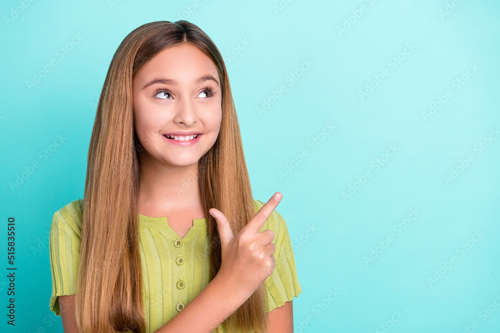 Photo of cheerful nice girl toothy smile look direct finger empty space isolated on vibrant teal color background Photo of cheerful nice girl toothy smile look direct finger empty space isolated on vibrant teal color background