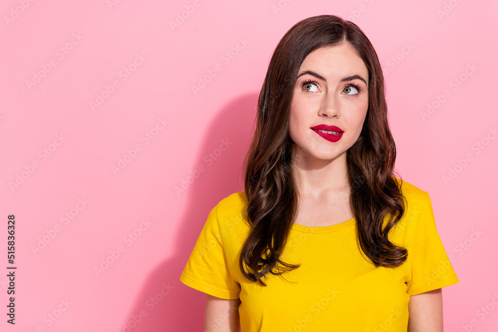 Photo of serious millennial brunette lady bite lip wear yellow t-shirt isolated on pink background Photo of serious millennial brunette lady bite lip wear yellow t-shirt isolated on pink background